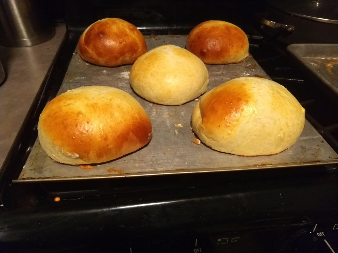 Cooked buns on a baking sheet.