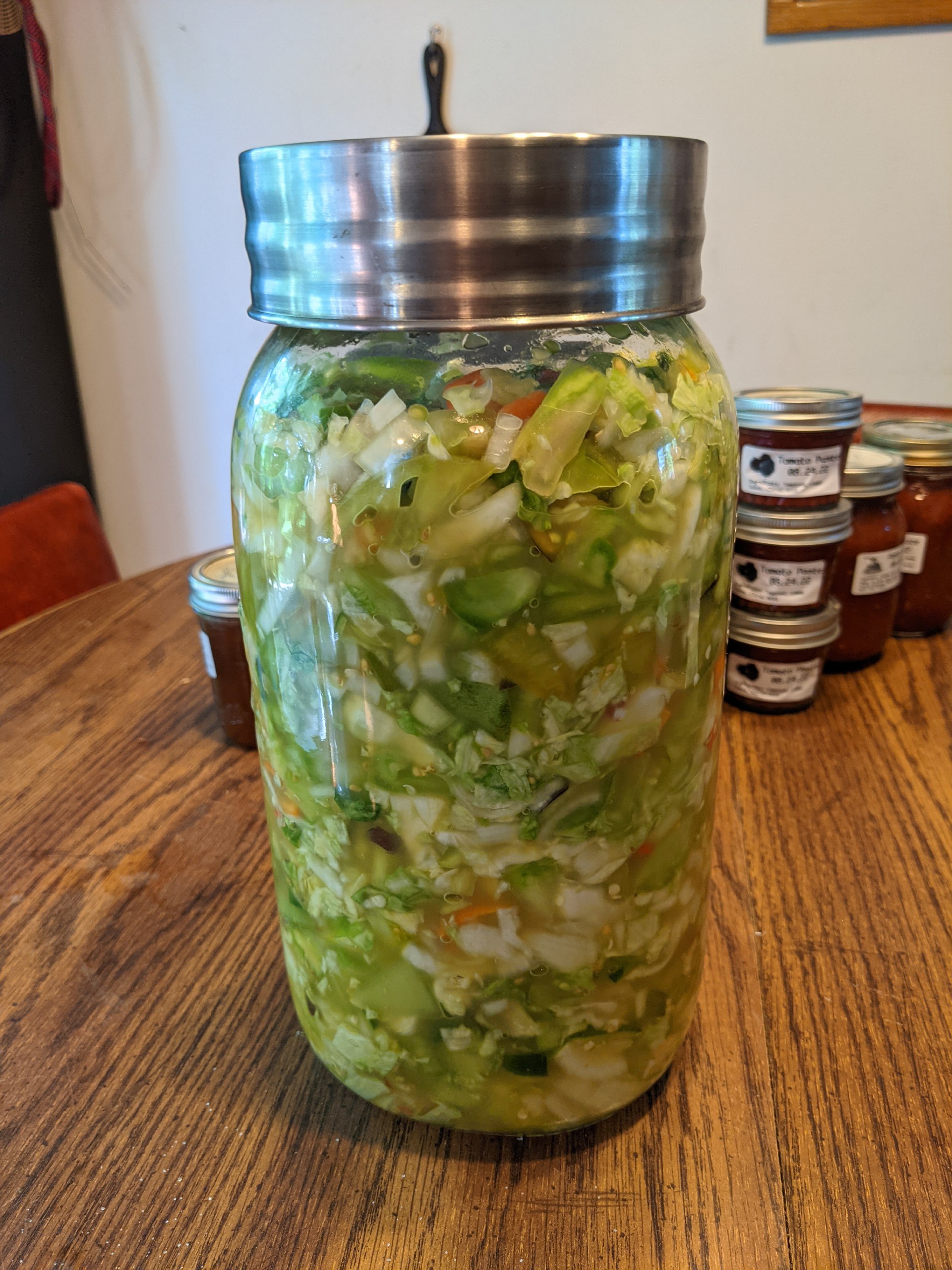 Chopped vegetables in jar with salt.