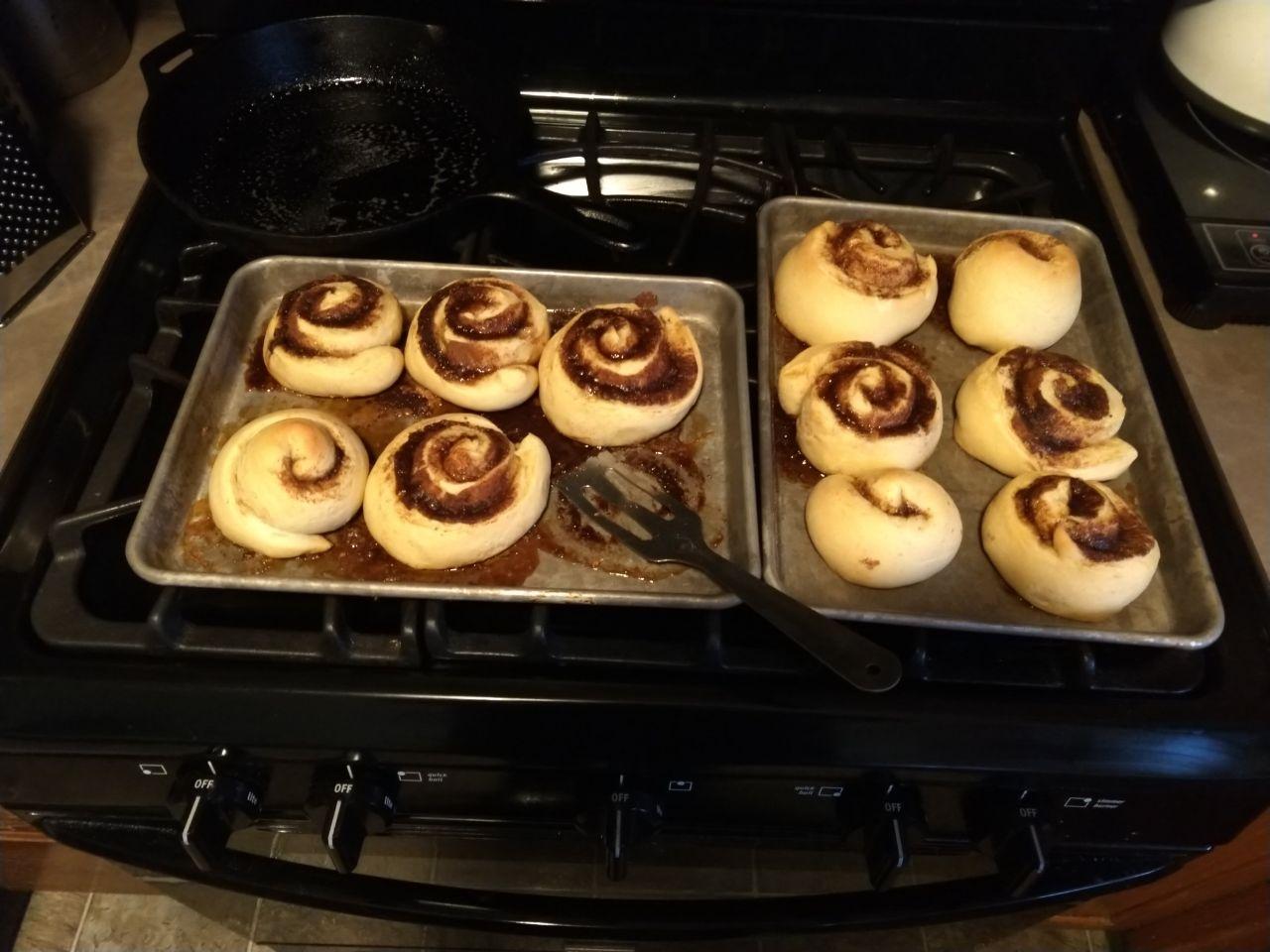 Cinnamon rolls after baking, cooling on the stove.