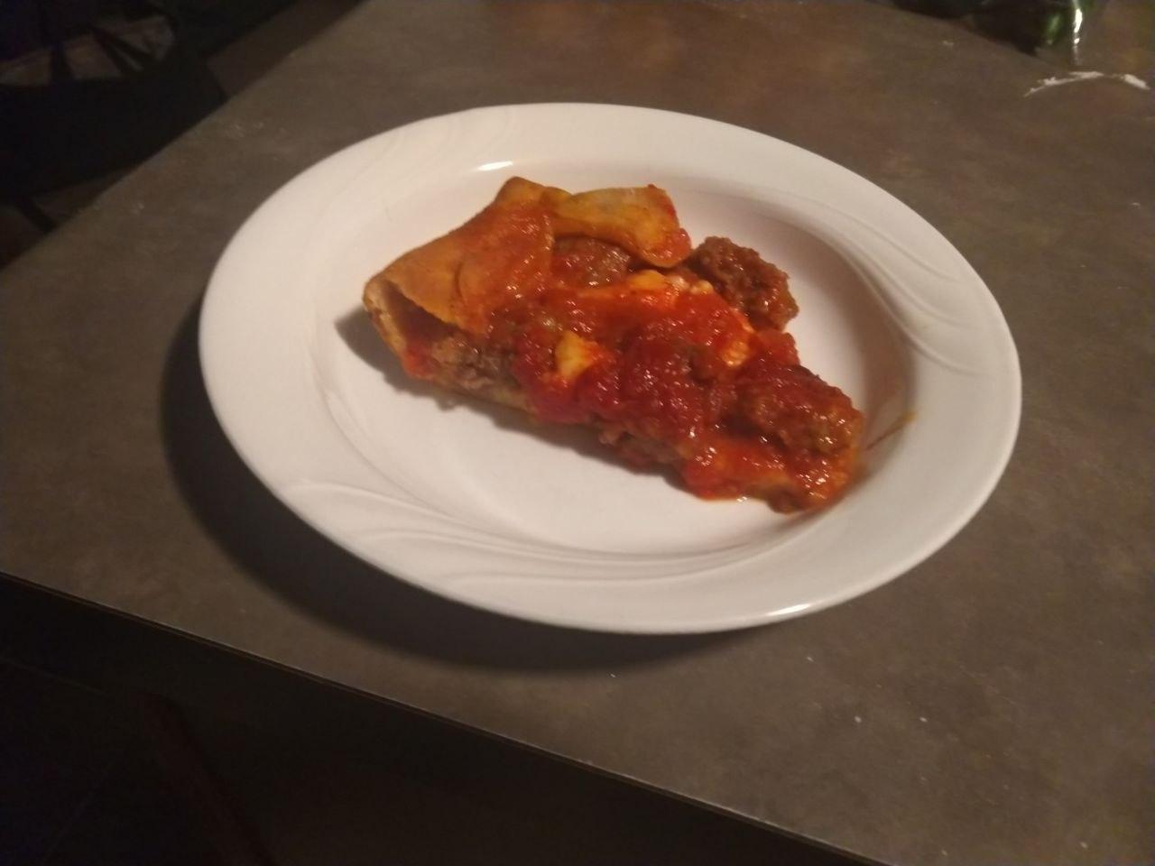 A slice of deep dish pizza.