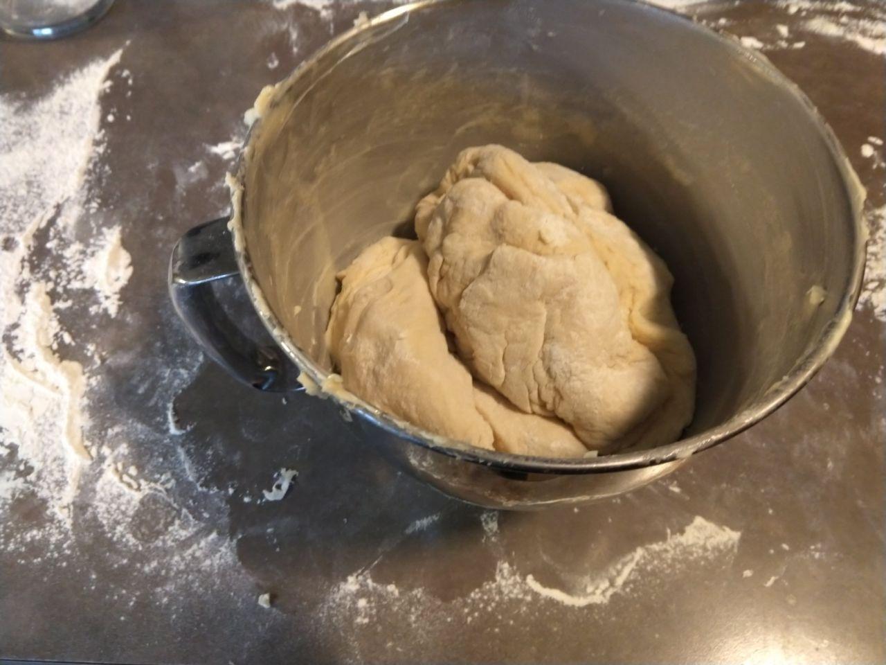 Dough in a greased mixing bowl after kneading, ready to rise.