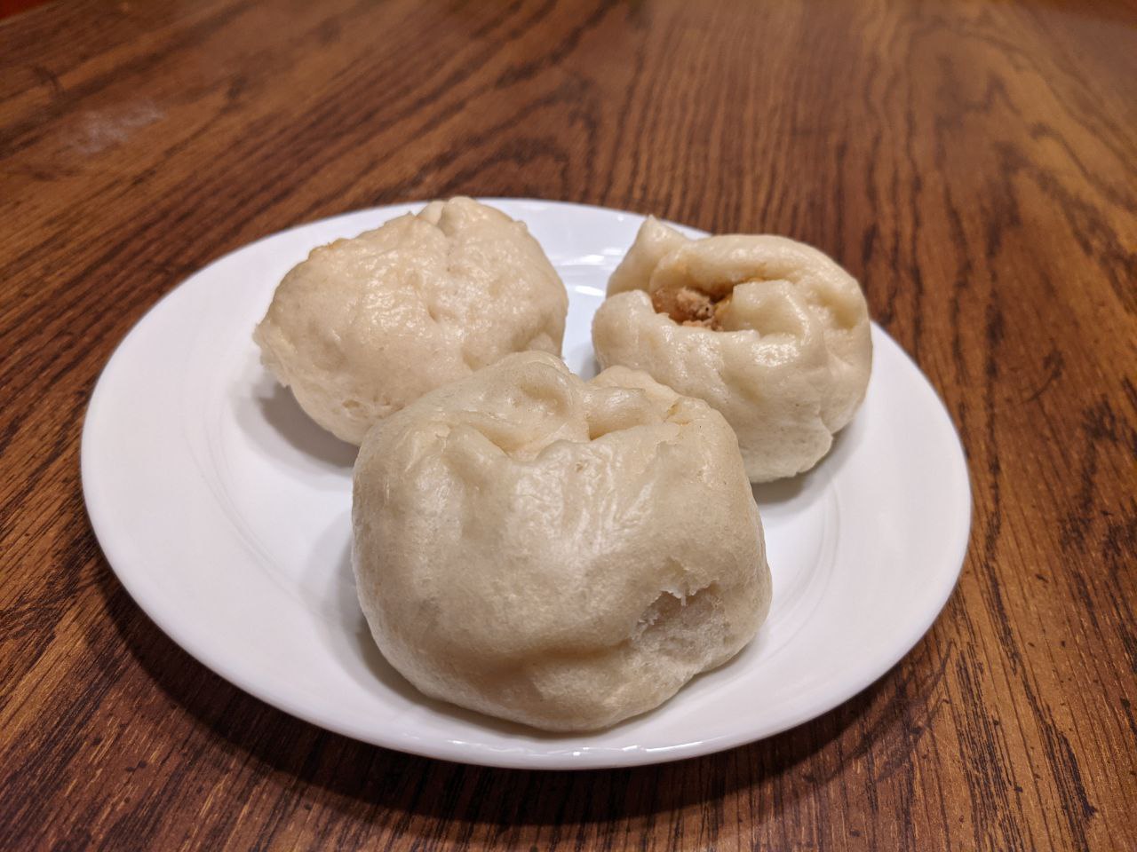 Three dumplings on a plate.