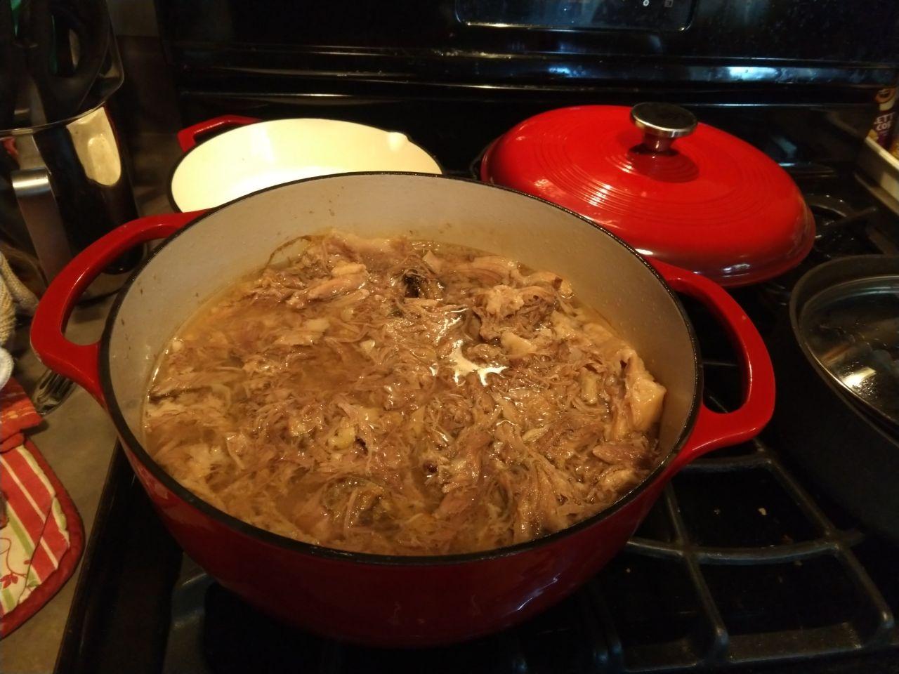 Dutch oven with shredded kalua pork. Dutch oven with shredded kalua pork.
