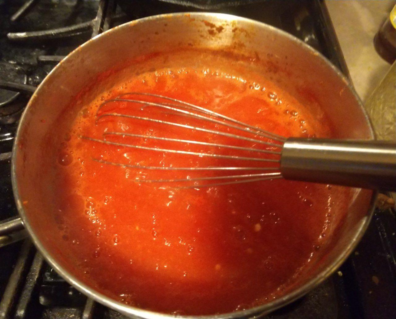 Ketchup cooking in a pot. Ketchup cooking in a pot.