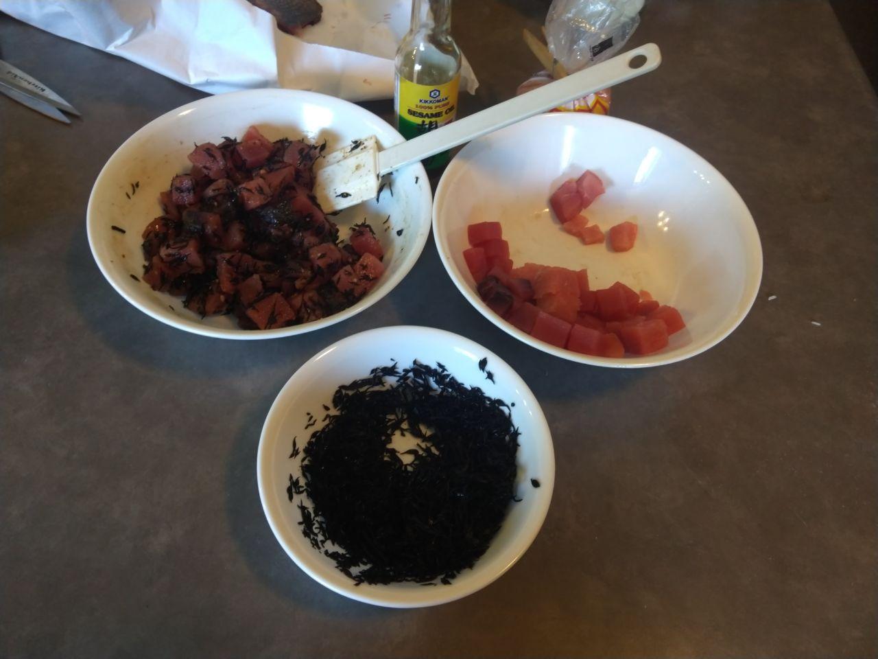 Bowl of poke being prepared with seaweed, kukui nuts, sesame oil, and salt. Bowl of poke being prepared with seaweed, kukui nuts, sesame oil, and salt.